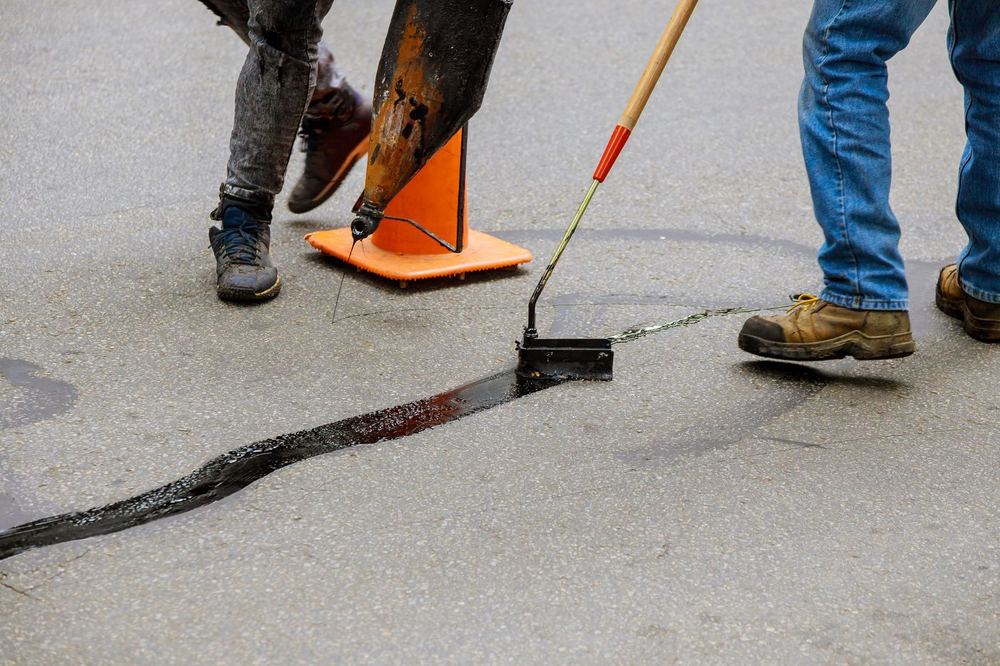 Crack seal being applied to asphalt