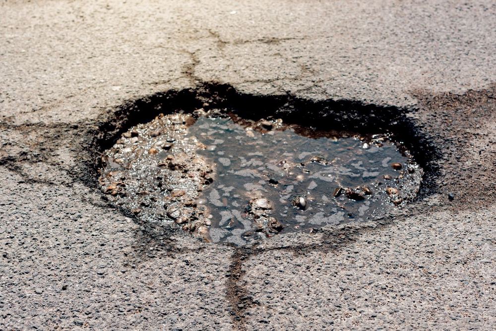 Pothole in an asphalt surface before repair